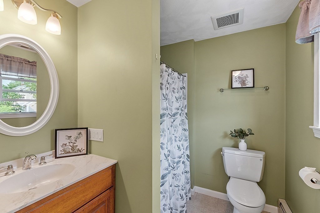 16 Choate Avenue Danvers, MA 01923 - Photo 14 of 32 a bathroom with a toilet sink and mirror