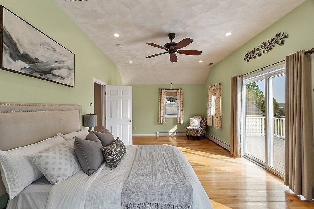 16 Choate Avenue Danvers, MA 01923 - Photo 10 of 32 a bedroom with a large bed and a chandelier