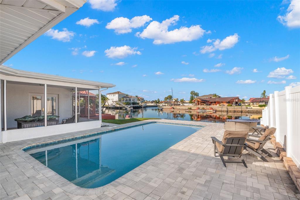 5451 Windward Way New Port Richey, FL 34652 - Photo 13 of 36 a view of a swimming pool with outdoor seating