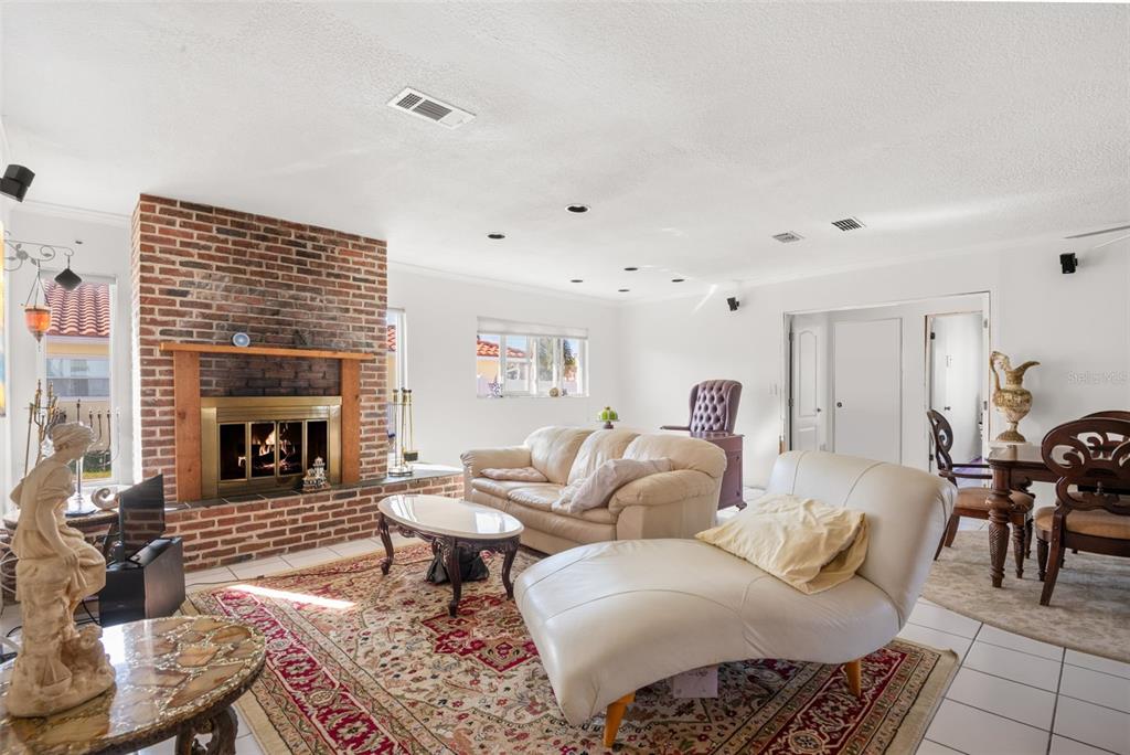 5451 Windward Way New Port Richey, FL 34652 - Photo 7 of 36 a living room with furniture and a fireplace