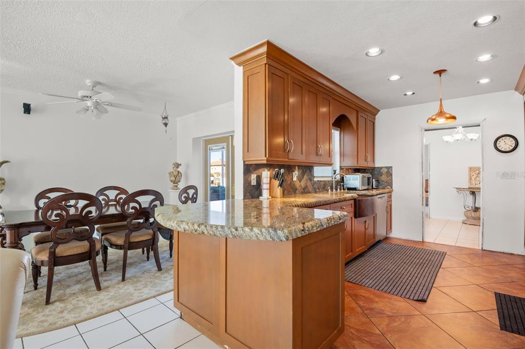 5451 Windward Way New Port Richey, FL 34652 - Photo 8 of 36 a kitchen with granite countertop a sink and a stove top oven