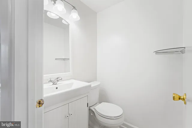 a bathroom with a sink a toilet and vanity