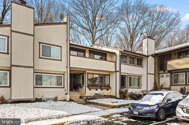 a front view of a house with a yard and seating space