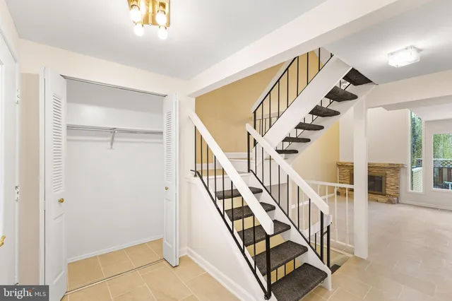 a view of entryway with wooden floor and stairs
