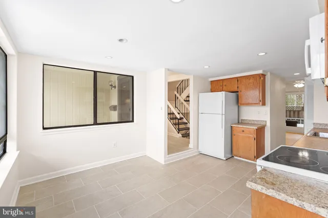 a kitchen with stainless steel appliances granite countertop a refrigerator and a stove top oven