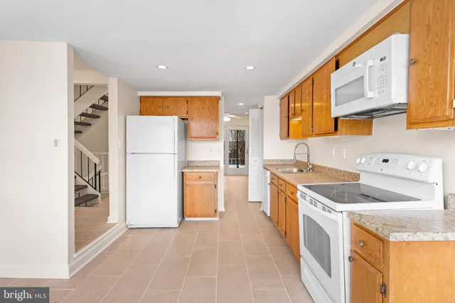 a kitchen with a sink a refrigerator and a stove