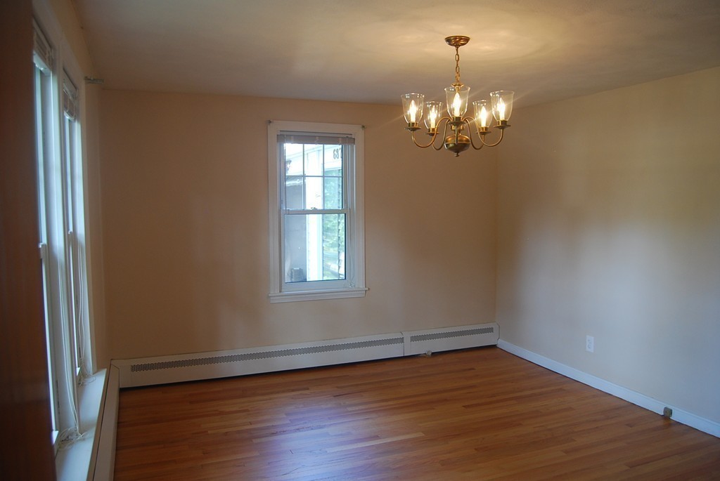 687 Plumtree Road Springfield, MA 01118 - Photo 13 of 27 a view of a chandelier in a room with a chandelier fan and wooden floor
