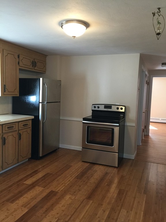 687 Plumtree Road Springfield, MA 01118 - Photo 6 of 27 a kitchen with a stove and a refrigerator