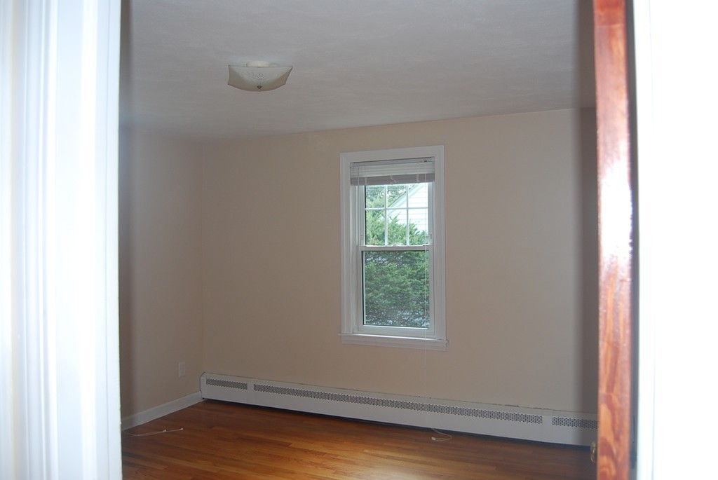 687 Plumtree Road Springfield, MA 01118 - Photo 9 of 27 a room view with wooden floor and windows