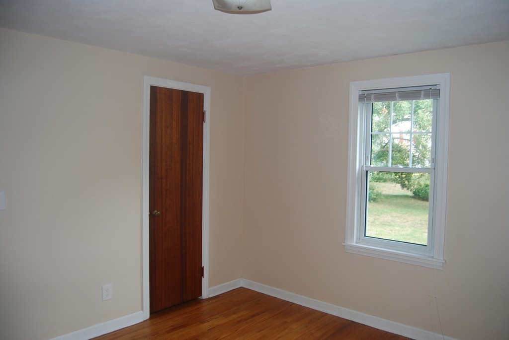 687 Plumtree Road Springfield, MA 01118 - Photo 10 of 27 a view of an empty room with wooden floor and a window