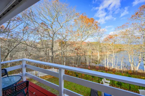 a bedroom with a bed and a dresser next to a window