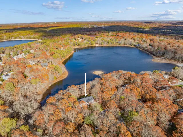a living room with lots of furniture and a large window