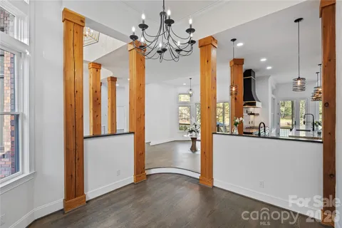 a view of a room with wooden floor and chandelier