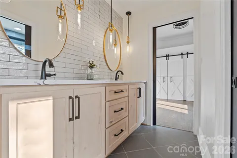 a view of a house with wooden floor next to a yard