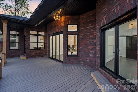 a view of a room with wooden floor and brick wall