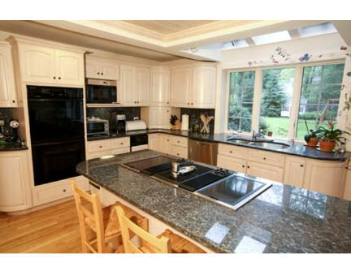 15 Lockeland Road Winchester, MA 01890 - Photo 2 of 24 a kitchen with stainless steel appliances kitchen island granite countertop a sink and cabinets
