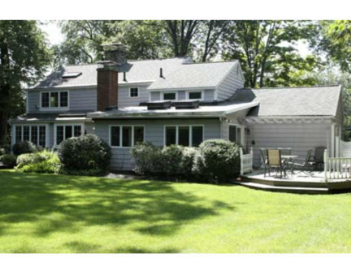 15 Lockeland Road Winchester, MA 01890 - Photo 22 of 24 a view of a white house next to a yard with big trees