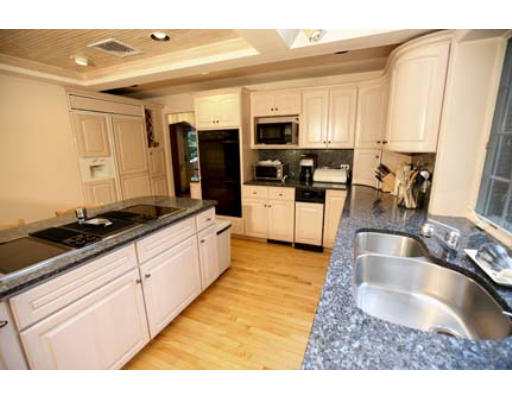 15 Lockeland Road Winchester, MA 01890 - Photo 4 of 24 a large kitchen with granite countertop a sink and white cabinets