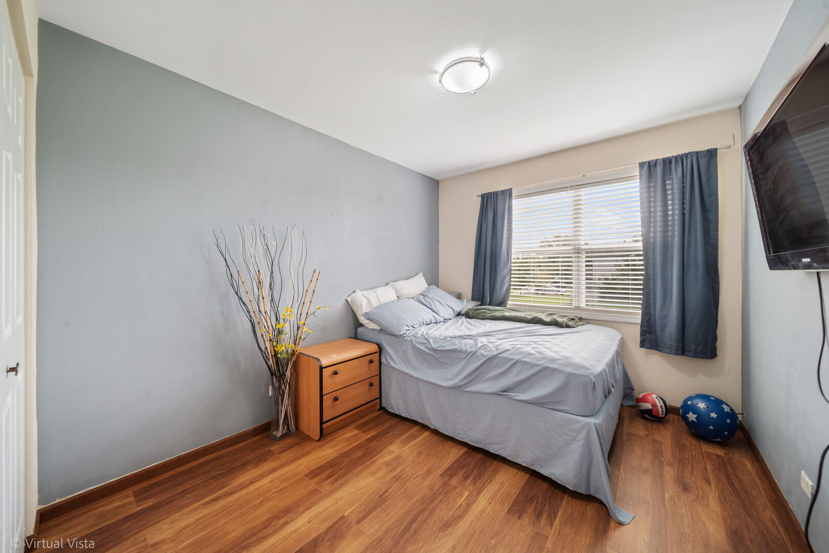 1402 Walnut Circle Carol Stream, IL 60188 - Photo 13 of 26 a bedroom with a bed and a flat tv screen on the dresser