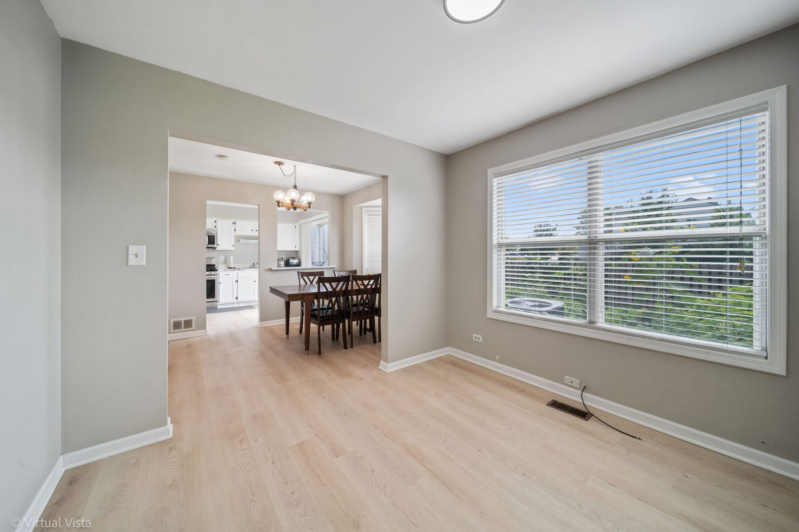 1402 Walnut Circle Carol Stream, IL 60188 - Photo 15 of 26 a view of an empty room with window and a kitchen