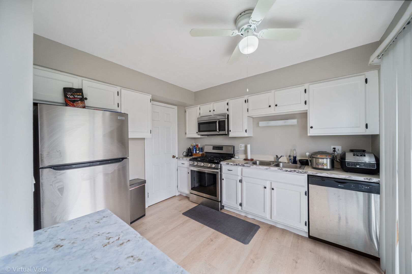 1402 Walnut Circle Carol Stream, IL 60188 - Photo 7 of 26 a kitchen with stainless steel appliances granite countertop white cabinets a refrigerator a stove a sink and white cabinets