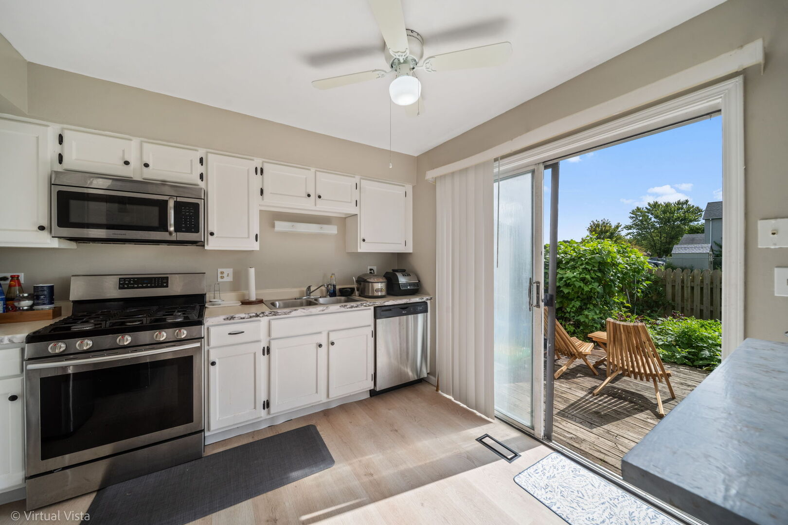 1402 Walnut Circle Carol Stream, IL 60188 - Photo 8 of 26 a kitchen with stainless steel appliances granite countertop a stove sink and cabinets