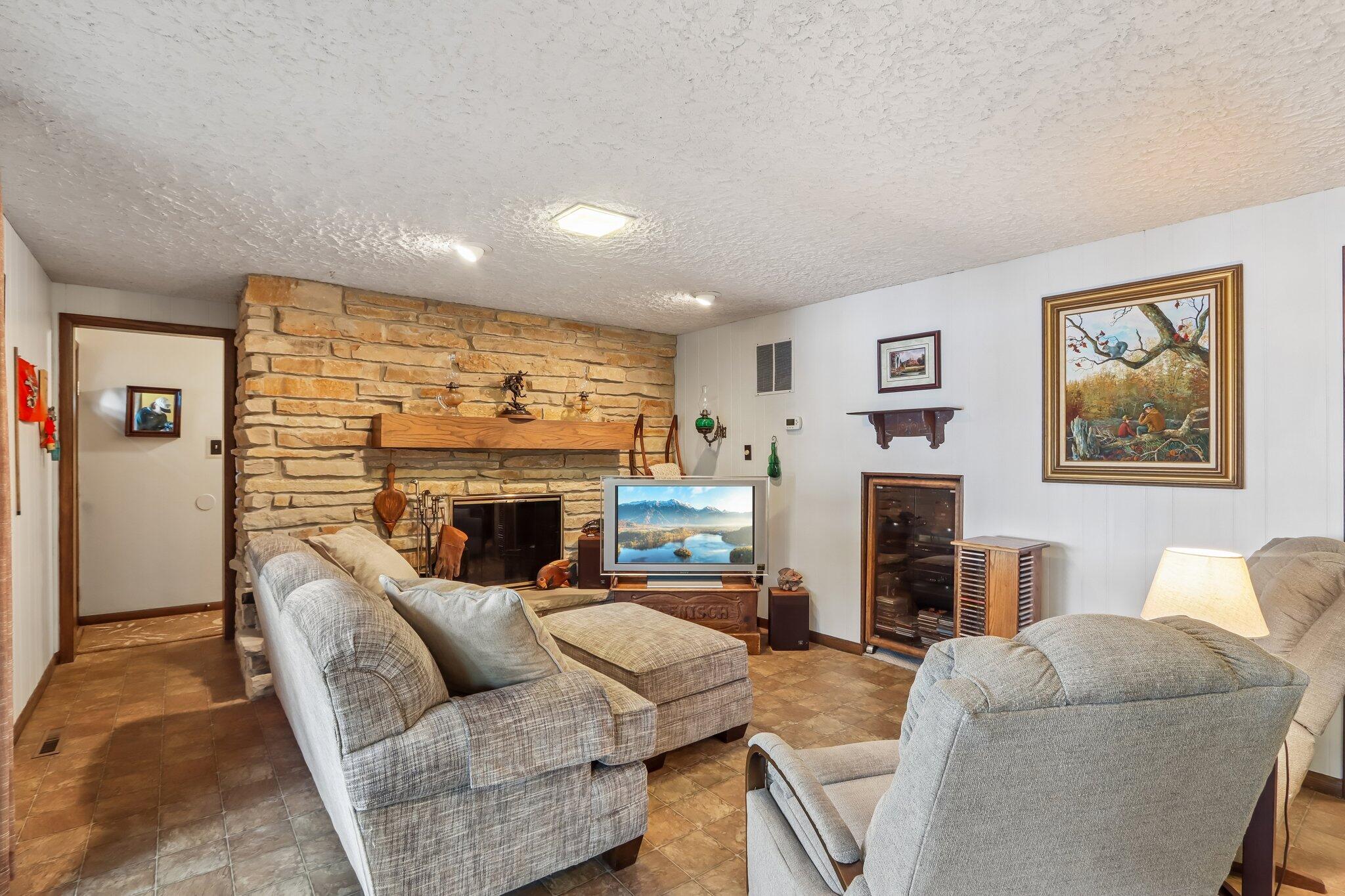 W322N6797 Wildwood Point Road Merton, WI 53029 - Photo 18 of 75 Lower level family room with fireplace