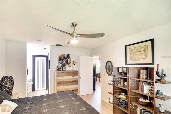 a view of a bedroom with furniture and closet