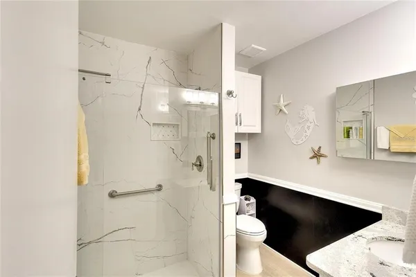 a picture of a bathroom with a sink and a shower