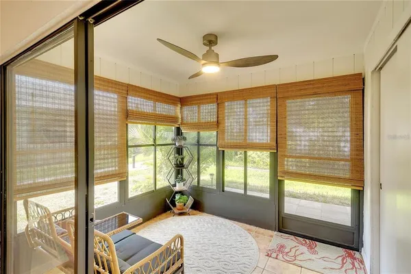 a bedroom with a bed and glass door