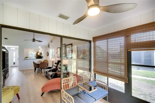 a living room with furniture and a floor to ceiling window