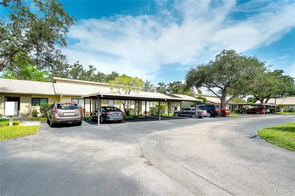 a view of a cars park in front of a building
