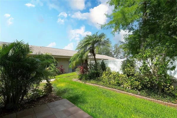 a view of a garden with a building in the background
