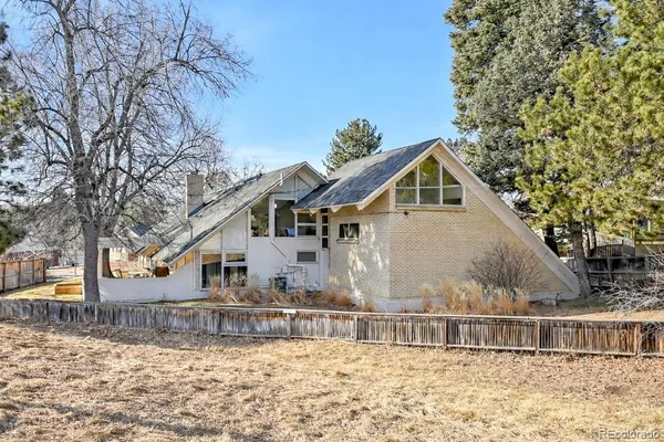 front view of a house with a chairs and table in a patio