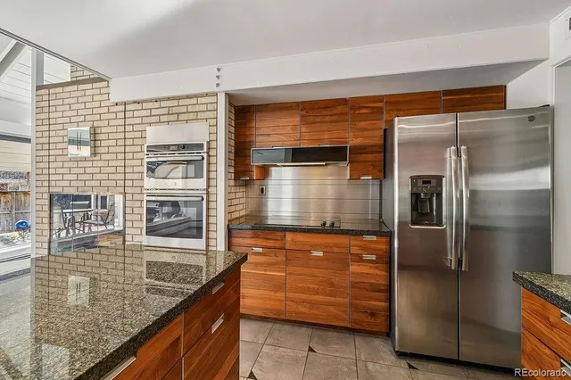 a kitchen with granite countertop stainless steel appliances and shower