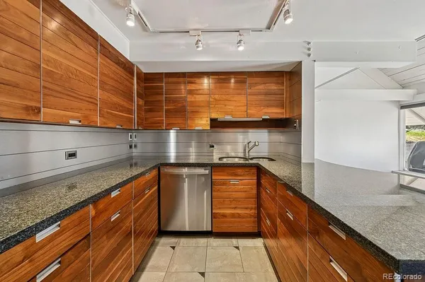 a kitchen with stainless steel appliances granite countertop a sink and cabinets