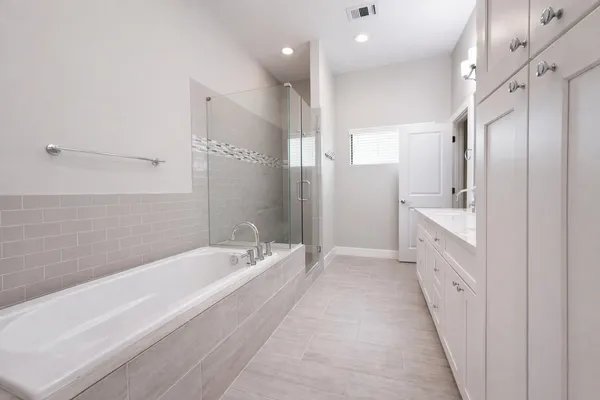 a spacious bathroom with a bathtub shower and a sink