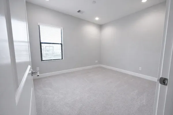 an empty room with windows and closet