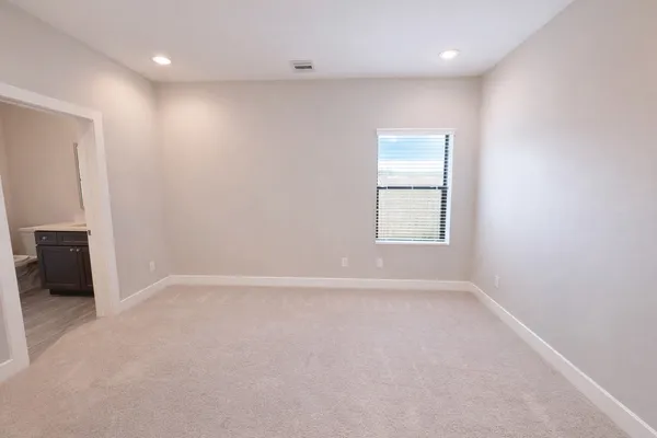 a view of an empty room with stairs and ventilation