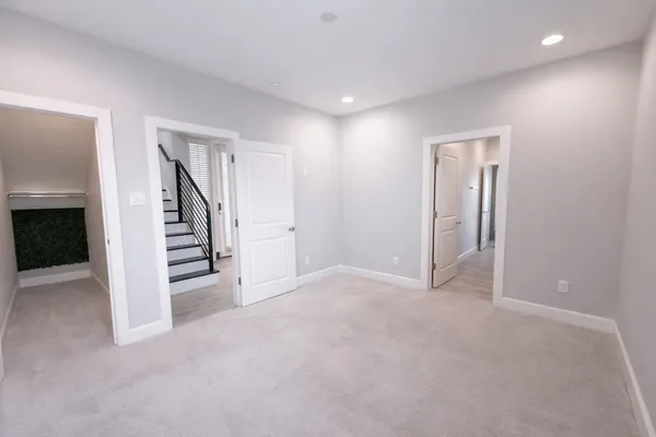 a spacious bathroom with a sink a toilet a shower and a mirror