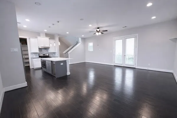 a view of kitchen and hall with wooden floor