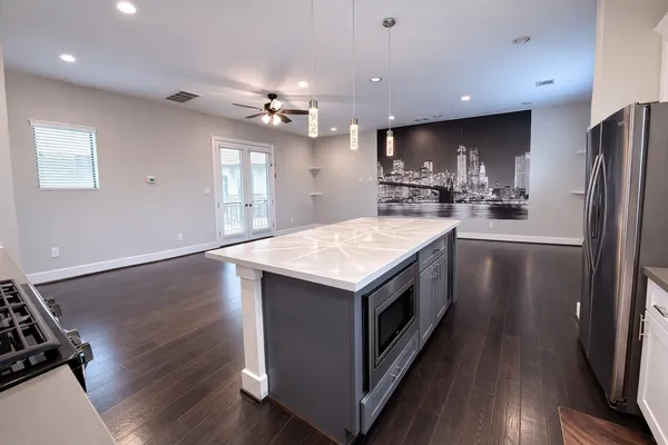 a kitchen with a stove a sink and a refrigerator