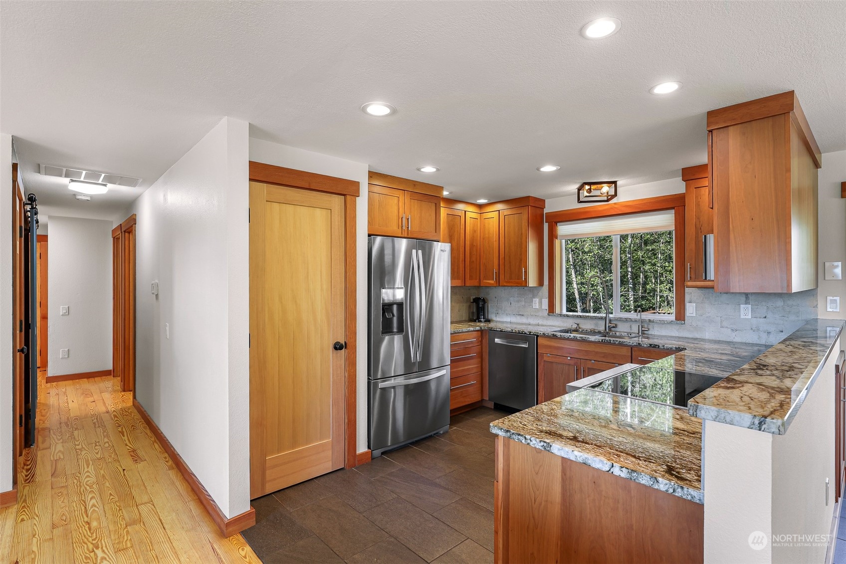 2993 Canlin Drive Ferndale, WA 98248 - Photo 11 of 35 a kitchen with stainless steel appliances granite countertop a refrigerator a sink a stove and oven