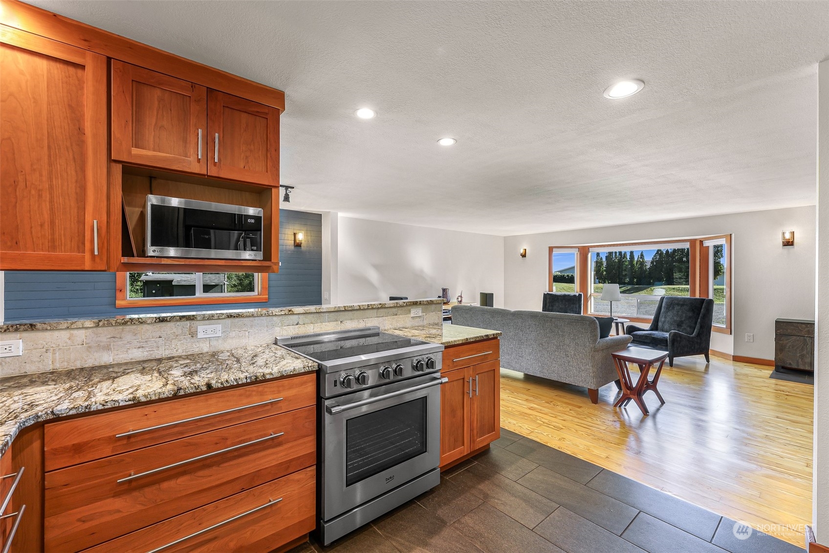 2993 Canlin Drive Ferndale, WA 98248 - Photo 13 of 35 a kitchen with stainless steel appliances granite countertop a stove and a wooden cabinets
