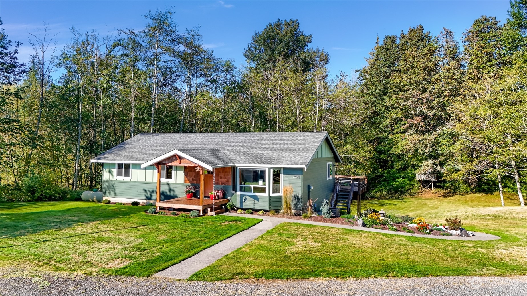 2993 Canlin Drive Ferndale, WA 98248 - Photo 2 of 35 a front view of a house with a yard table and chairs