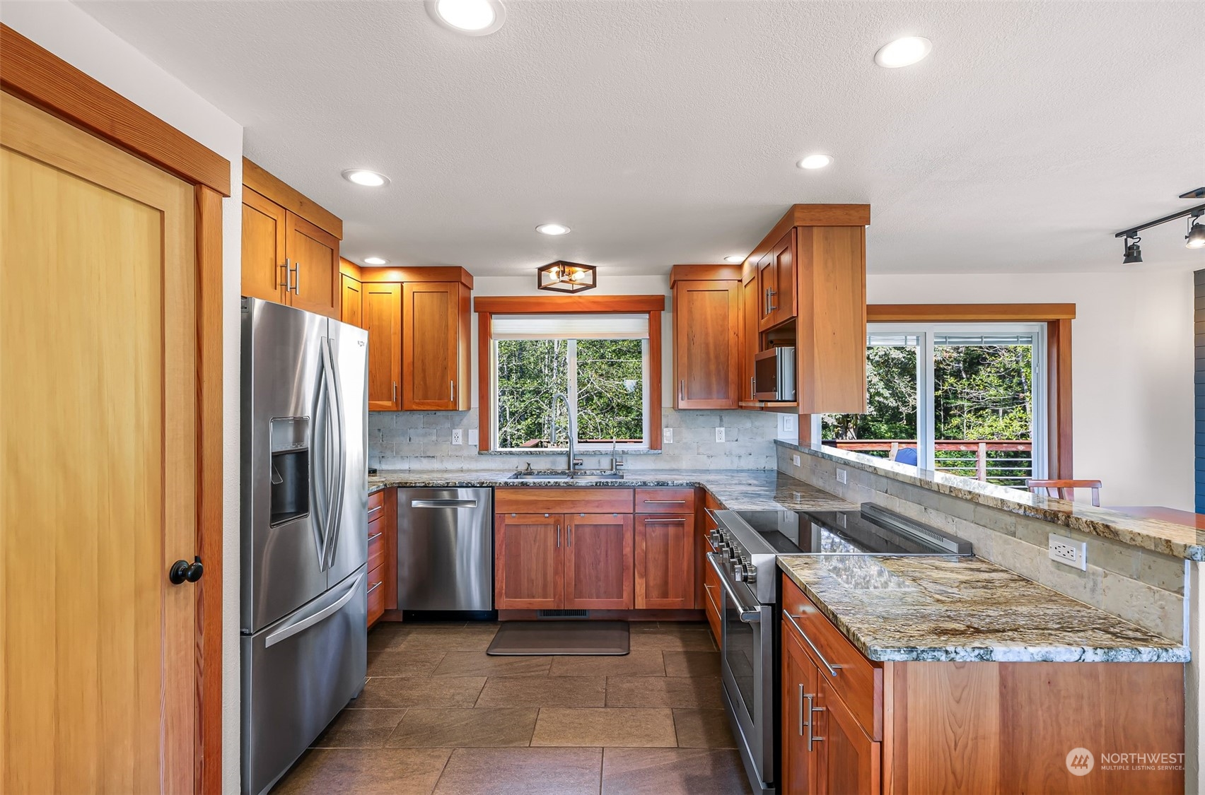 2993 Canlin Drive Ferndale, WA 98248 - Photo 10 of 35 a kitchen with large windows and refrigerator