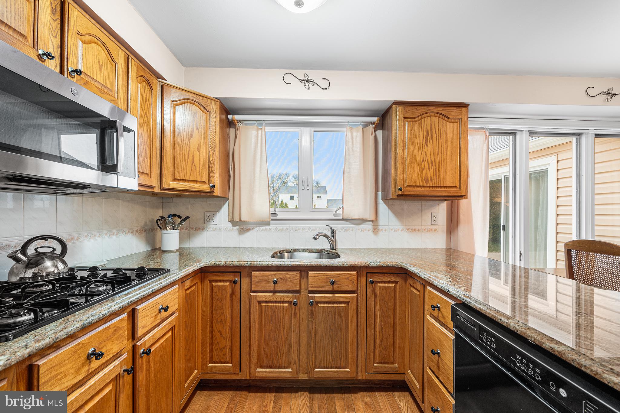 1571 Carousel Drive Warminster, PA 18974 - Photo 12 of 40 a kitchen with stainless steel appliances granite countertop a sink a stove and cabinets