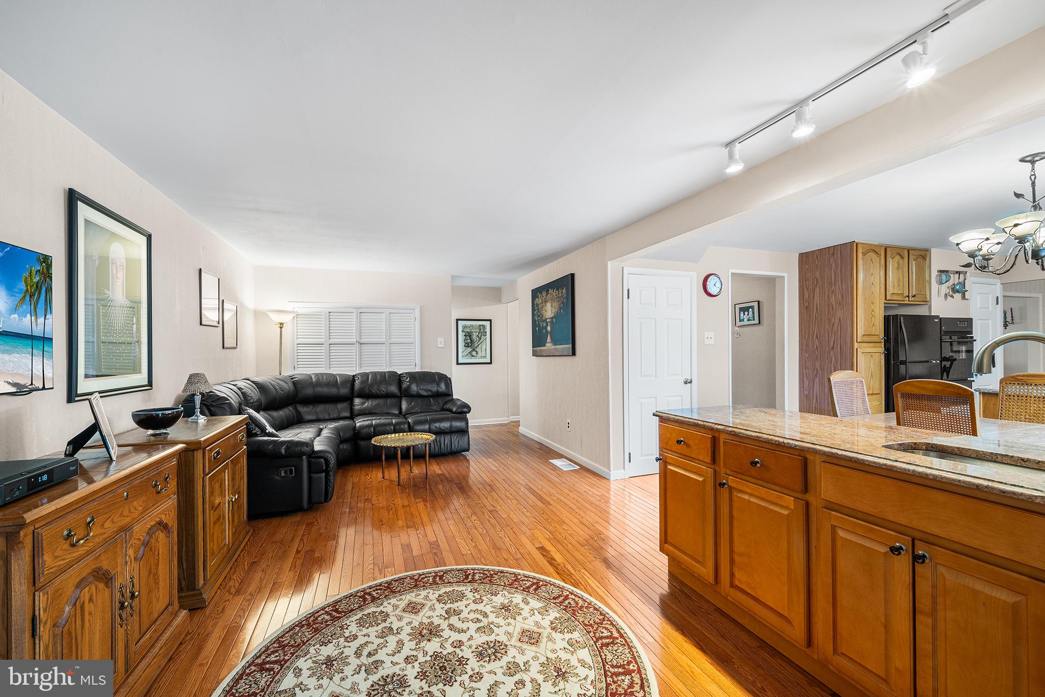 1571 Carousel Drive Warminster, PA 18974 - Photo 17 of 40 a kitchen with stainless steel appliances granite countertop a sink dishwasher stove and wooden cabinets