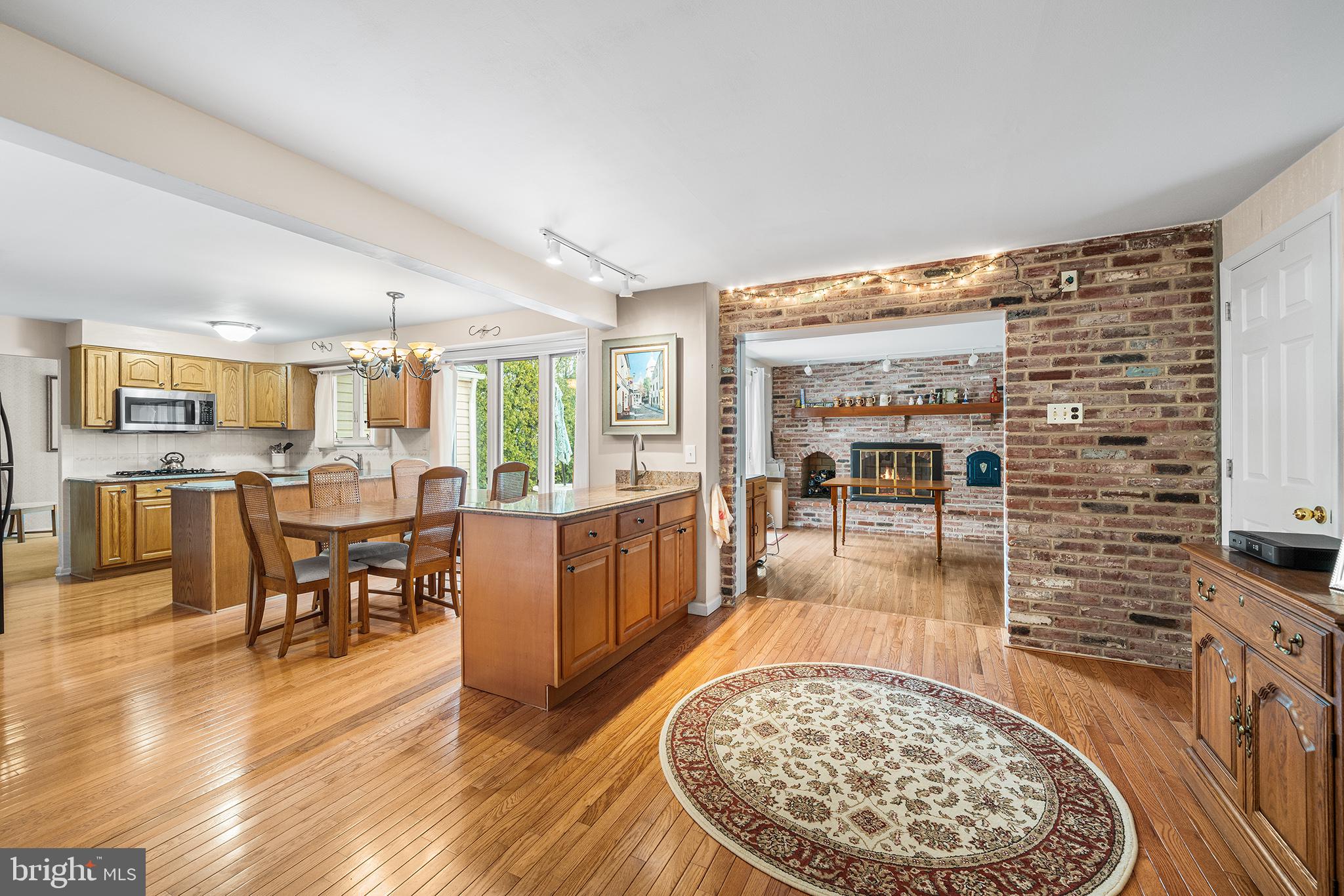1571 Carousel Drive Warminster, PA 18974 - Photo 18 of 40 a living room with couches and kitchen view with wooden floor