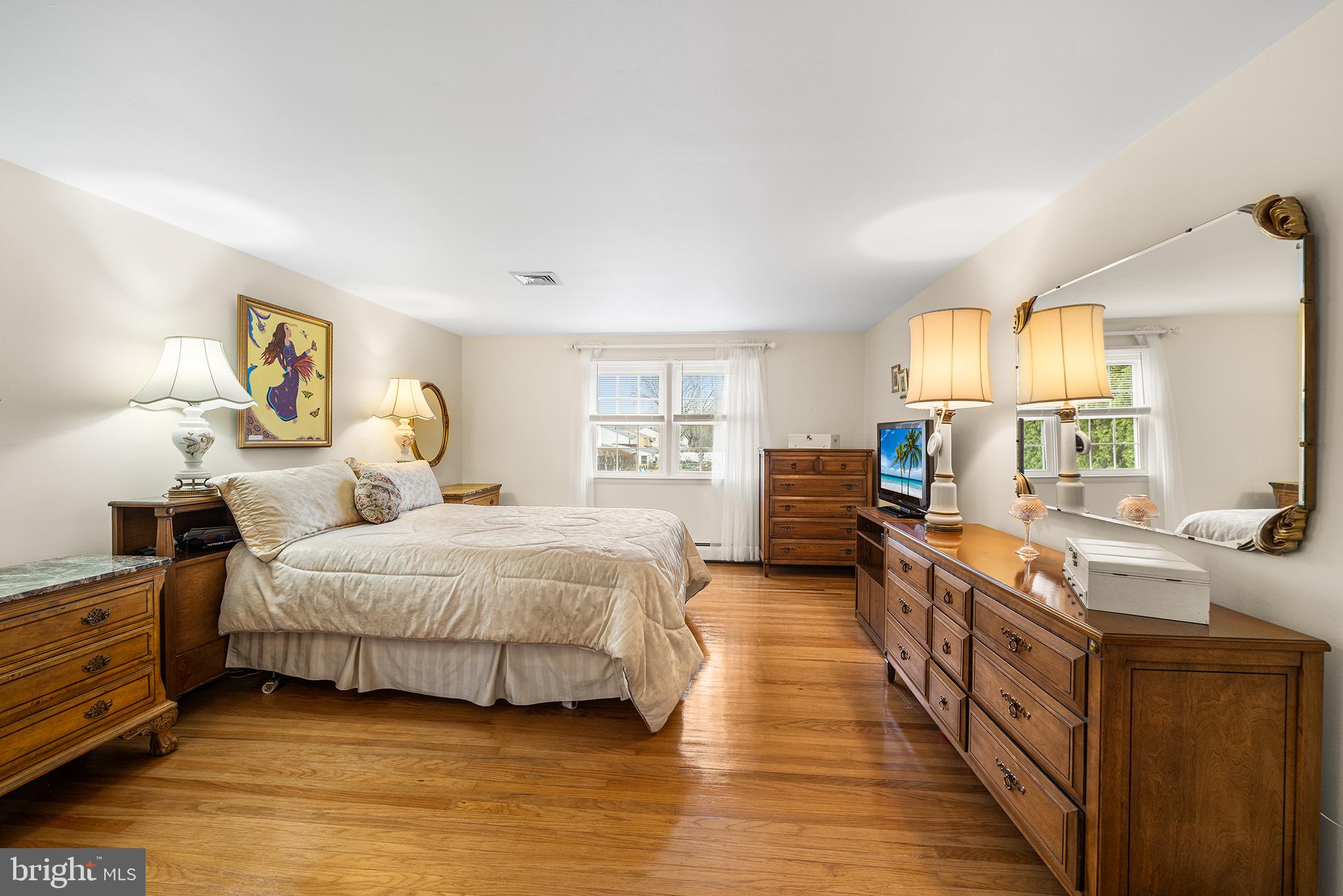 1571 Carousel Drive Warminster, PA 18974 - Photo 28 of 40 a spacious bedroom with a bed a dresser and wooden floor